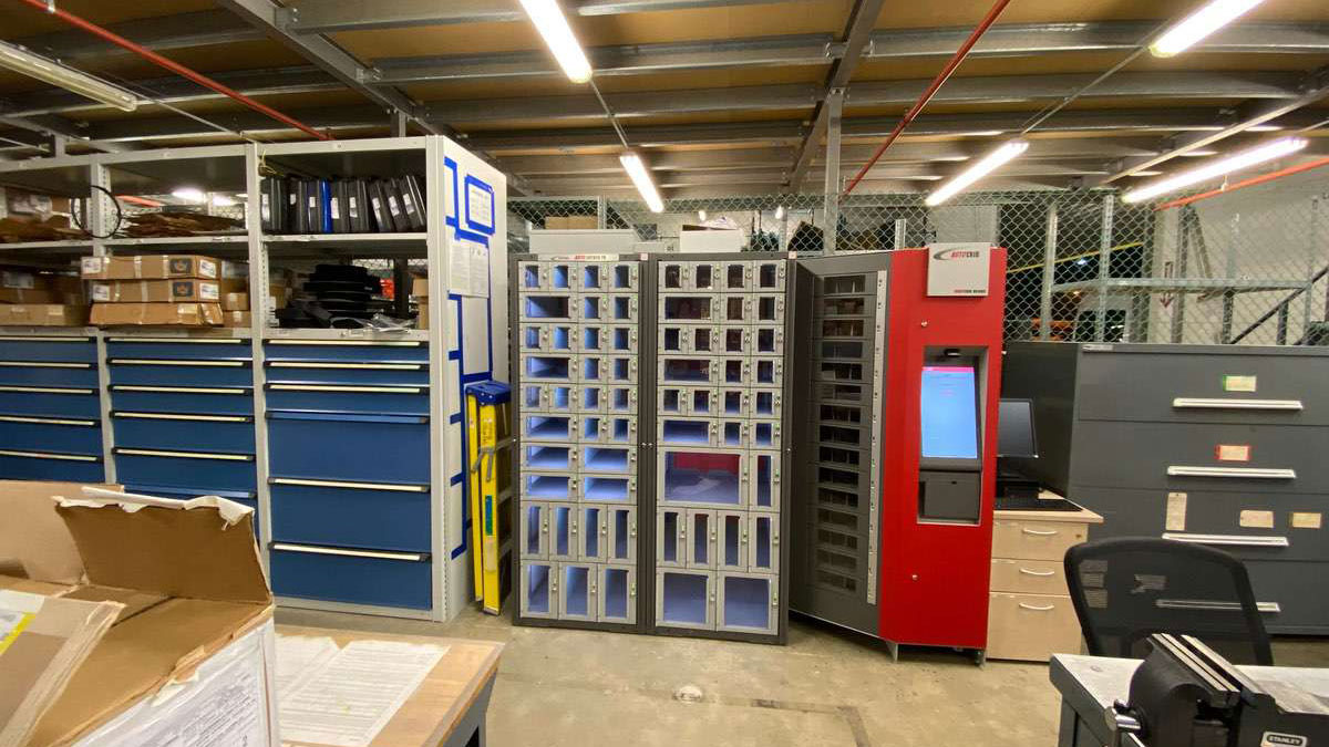 Inventory control setup featuring vending lockers and blue drawer cabinets for tool storage and parts distribution