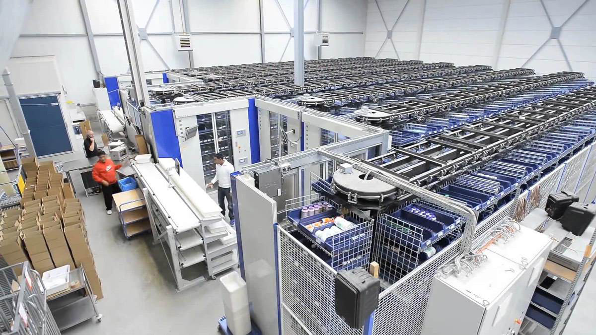 Automated horizontal carousel picking system operating in a high-capacity fulfillment center with multiple picking bays and ergonomic workstation layout