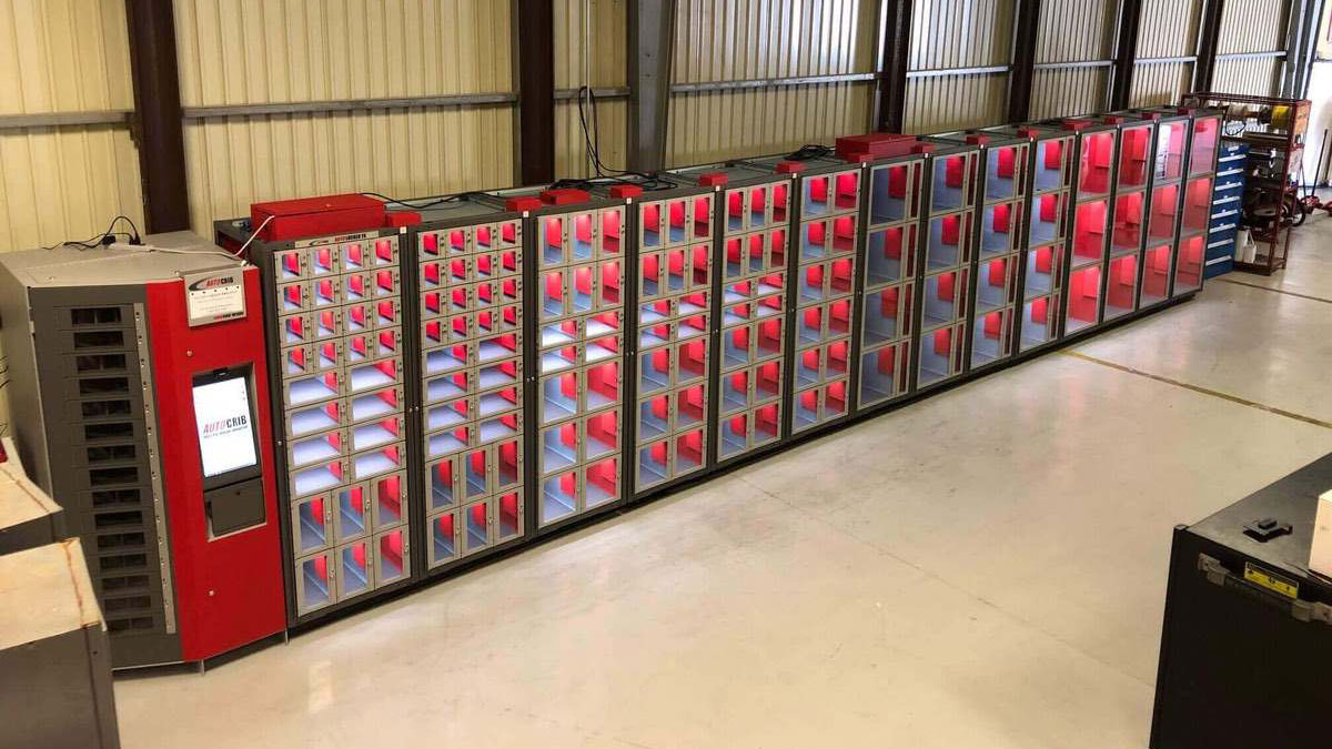 Wall of industrial vending machines with automated tool dispensing compartments for organized supply management in a warehouse setting