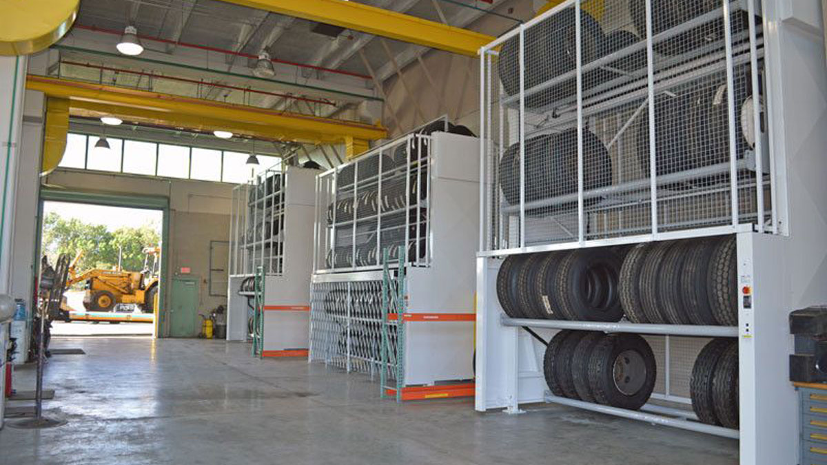 Multiple vertical tire carousels in a maintenance facility for storing large industrial and commercial tires