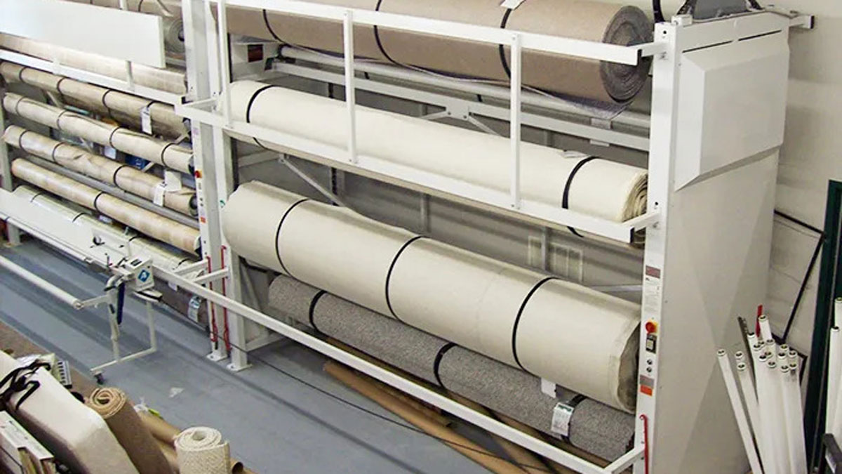 Manual carpet storage rack designed for organizing multiple carpet rolls horizontally in a showroom or warehouse
