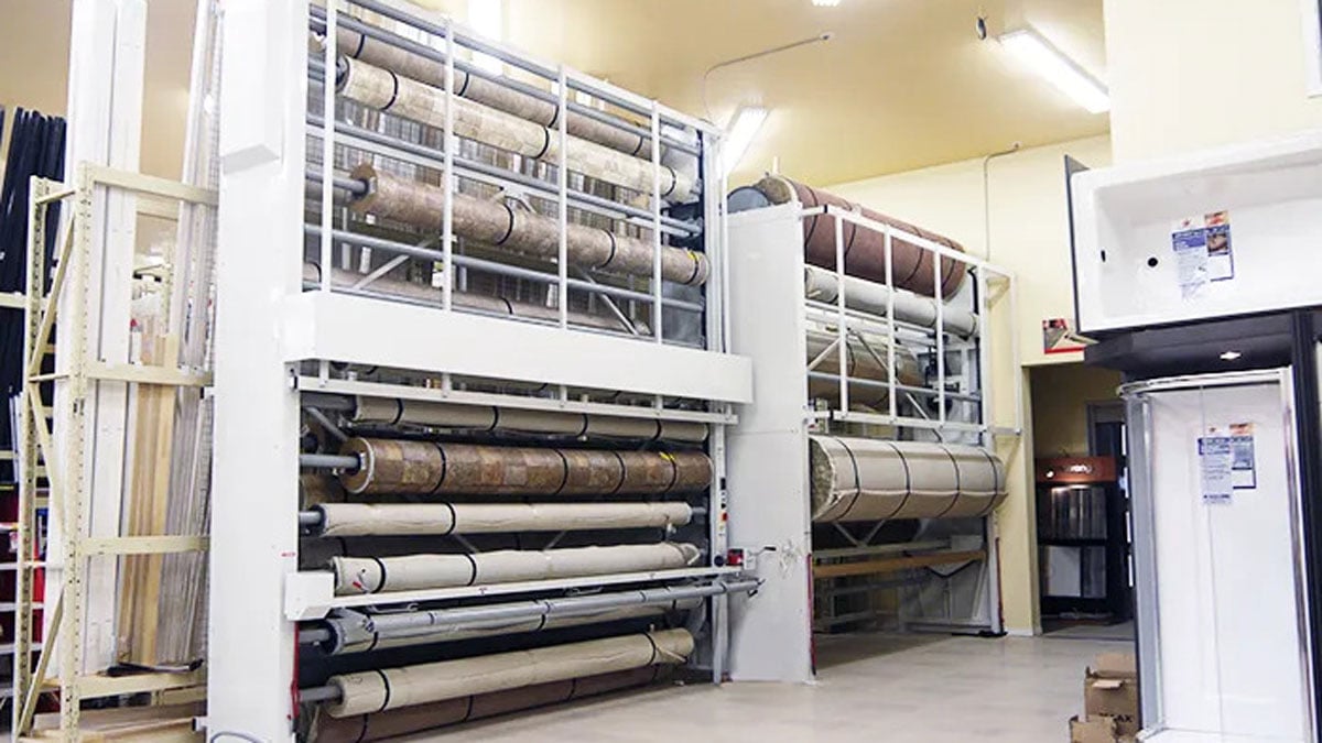 Automated vertical carousel storing large carpet rolls for flooring showrooms and warehouses