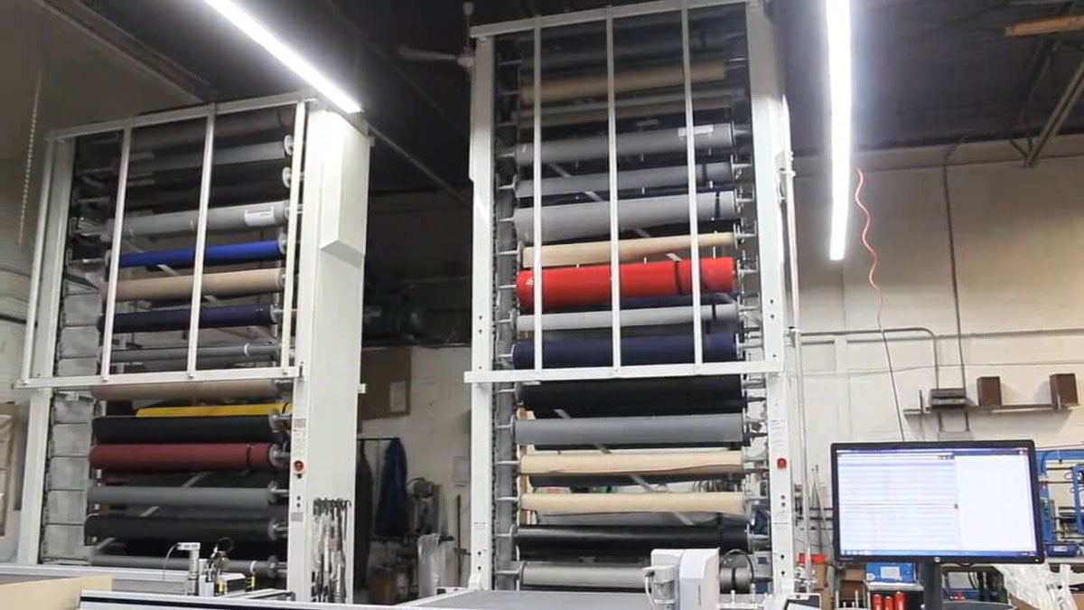 Automated vertical fabric roll carousel for organized textile inventory and fast access