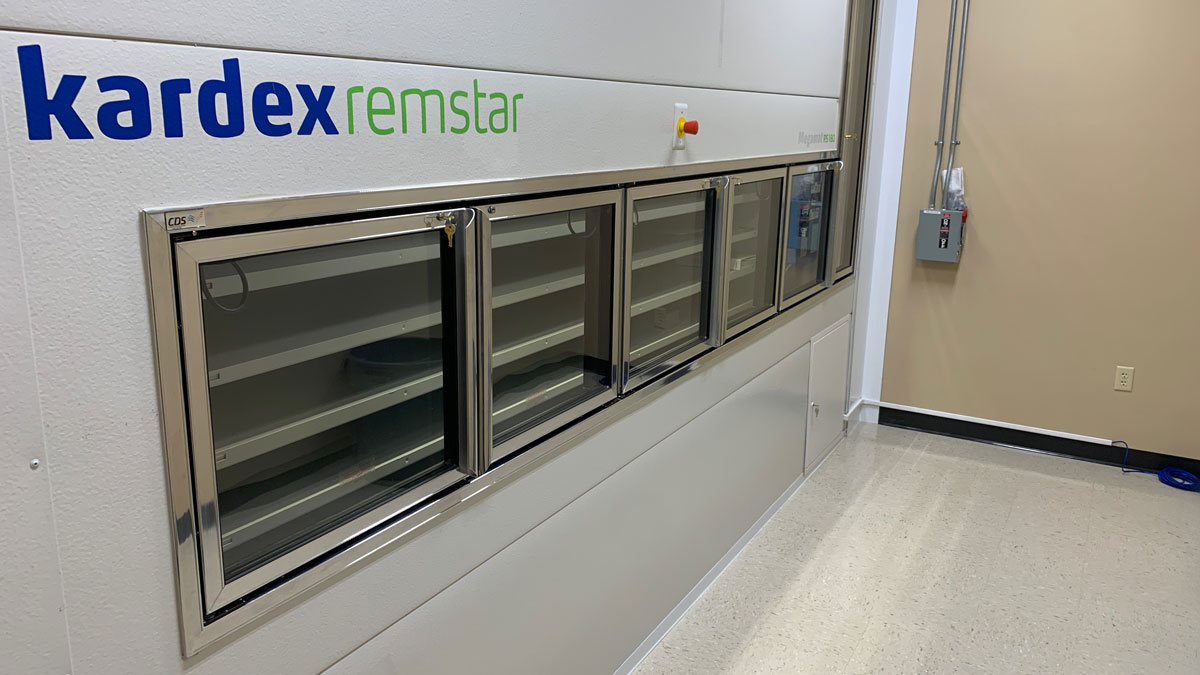 Kardex vertical carousel storage system installed in a compact room with bright overhead lighting and a clean, sterile environment
