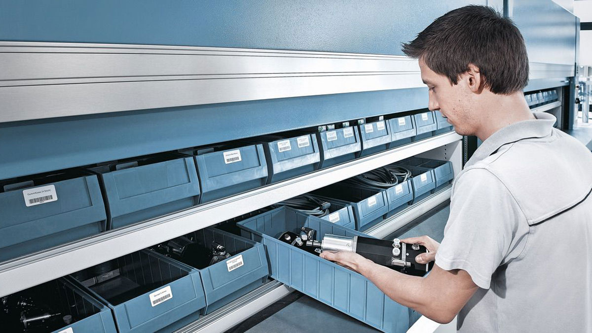 Warehouse worker accessing bins in a Kardex Megamat vertical carousel