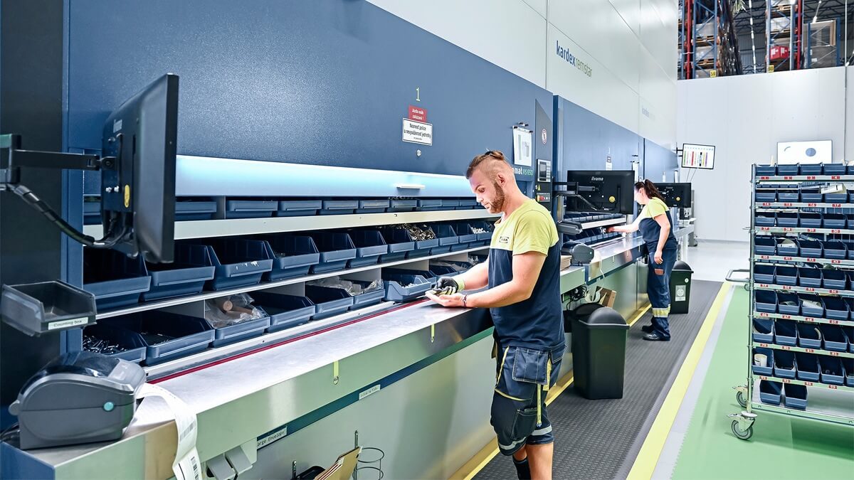 Employee organizing inventory in a vertical carousel at an distribution center