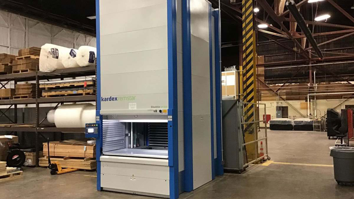 Warehouse employee accessing goods from Kardex vertical lift module system