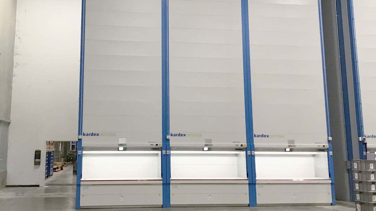 Tall Kardex Remstar vertical lift modules installed at a Lockheed Martin facility, showcasing high-density storage in a modern warehouse