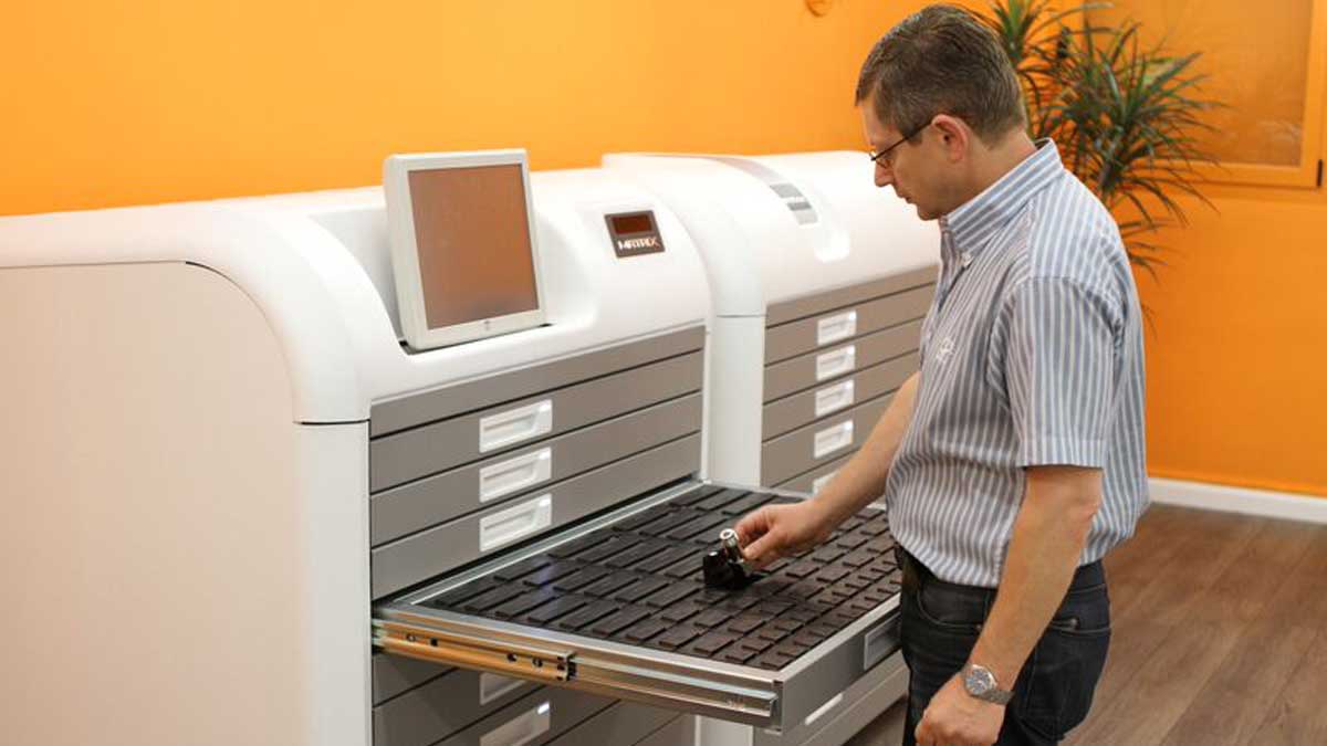 technician retrieving key from high density electronic key cabinet for key control and tracking