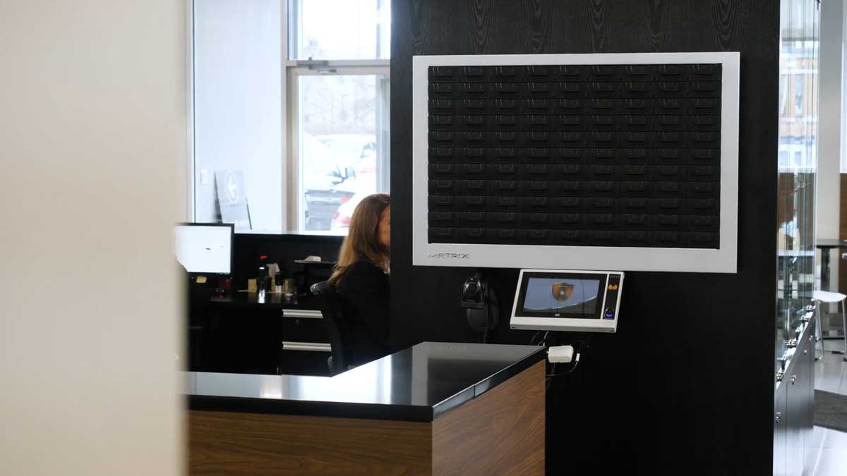 wall mounted electronic key storage panel controlling access and tracking key usage at reception desk