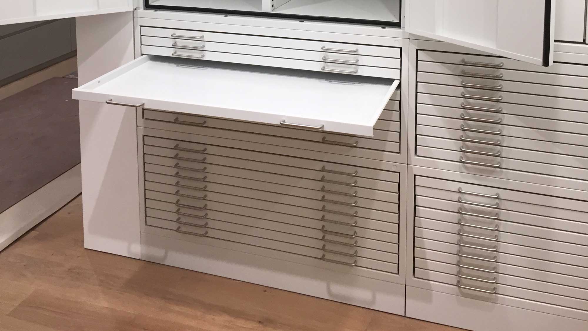 Flat file cabinets storing large format drawings and maps in shallow drawers