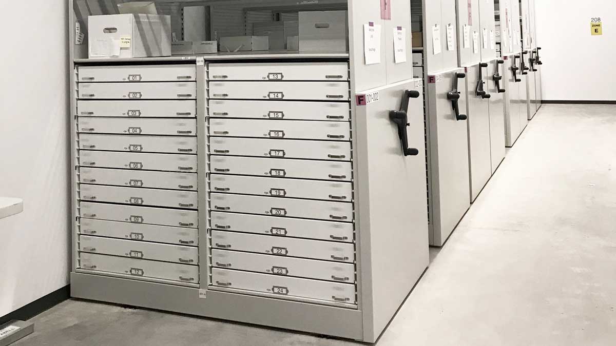 Flat file trays integrated in four-post shelving for plan storage