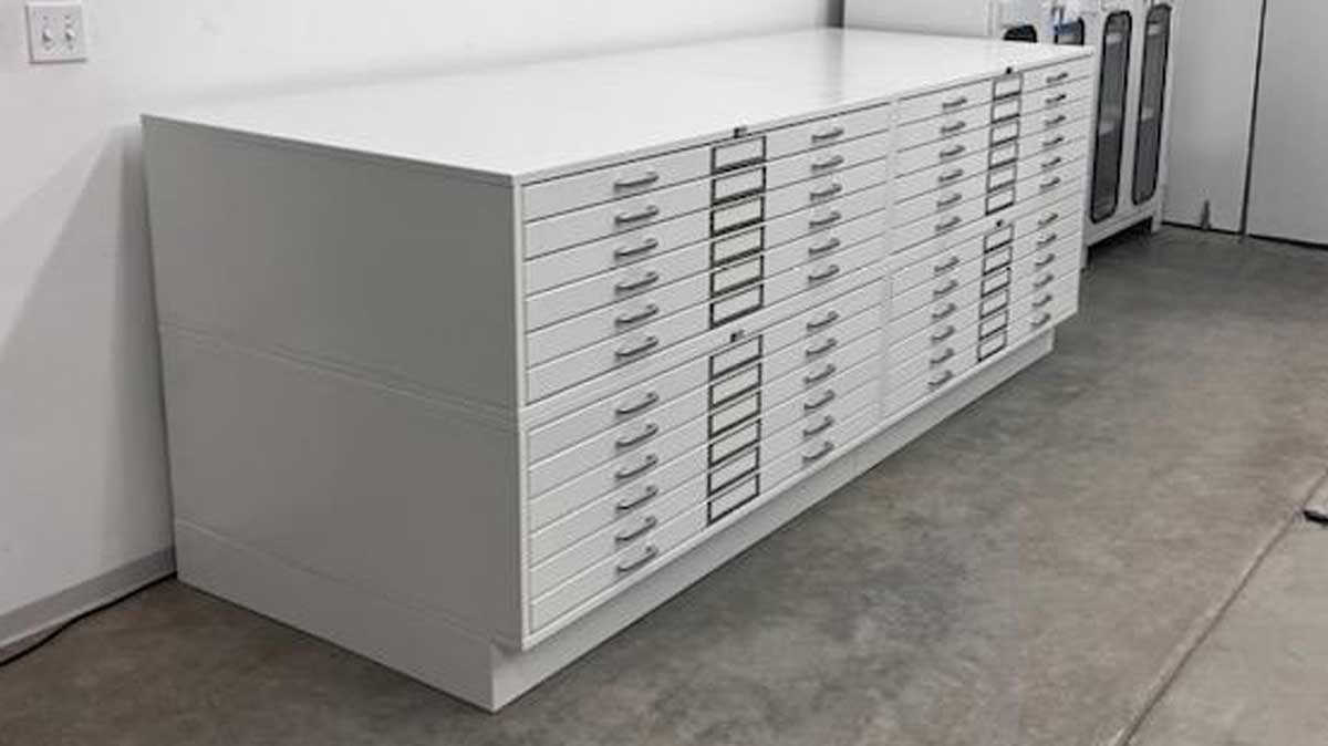 Row of flat file cabinets storing artwork in a museum backroom