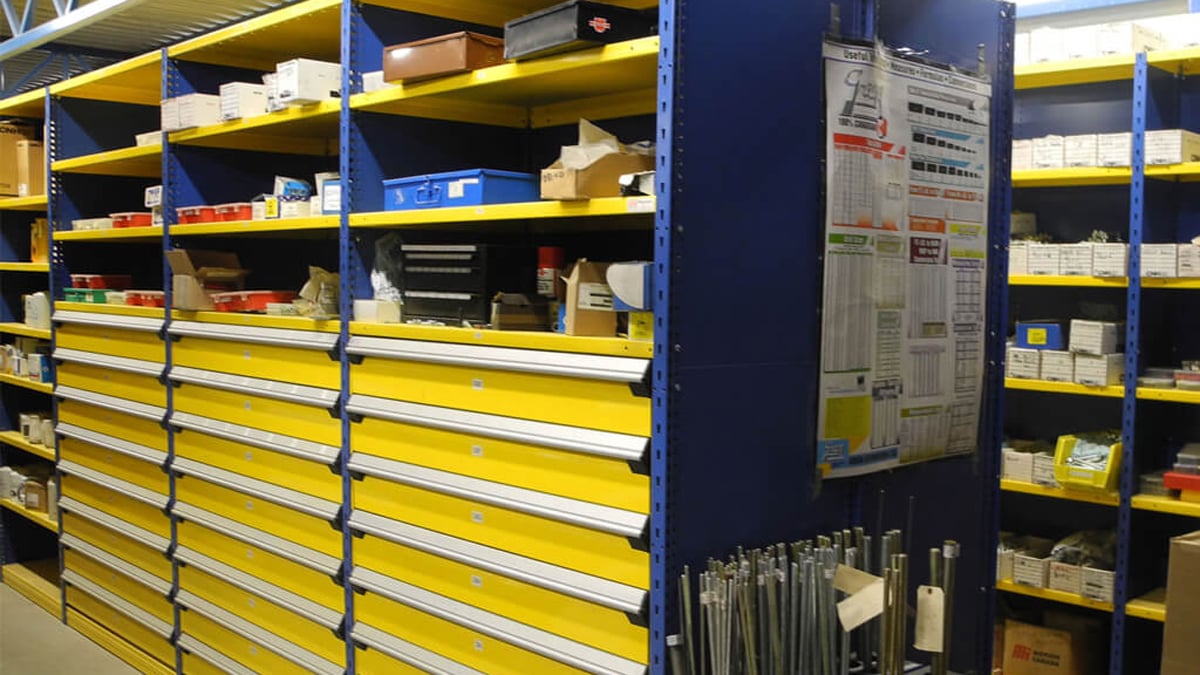 Yellow and blue modular drawer storage for manufacturing parts and tools.