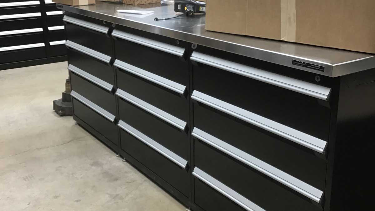 Rolling modular drawer cabinet with locking casters in a shop.
