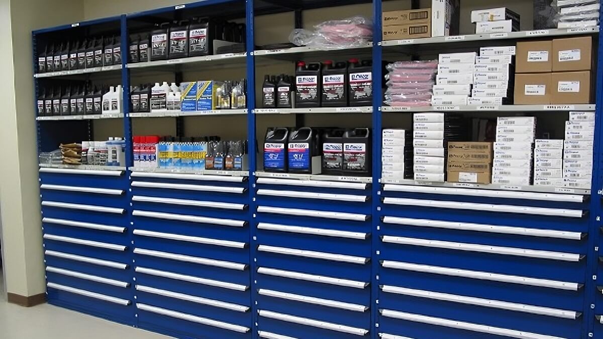 Modular drawer cabinets with upper shelves stocked with labeled parts. 