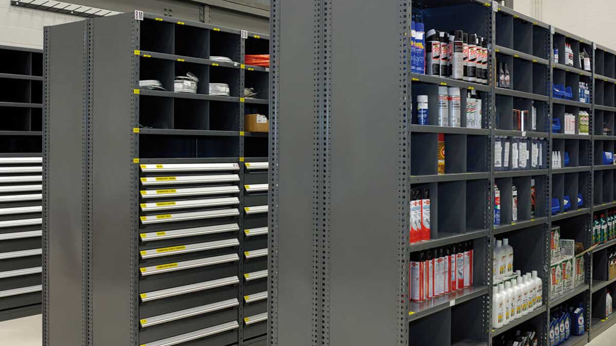 Grey modular drawer cabinets and cubby shelves stocked with maintenance and cleaning supplies. 