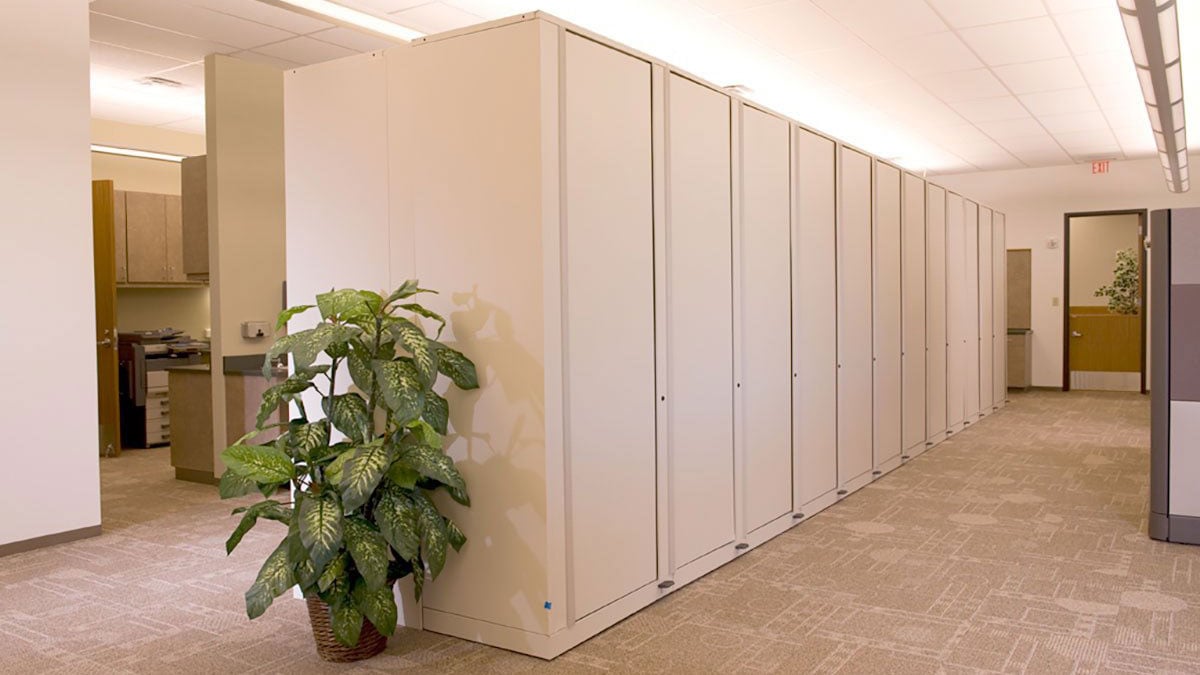 rotary file cabinets in an open office corridor with beige carpet and natural lighting for space-efficient document storage