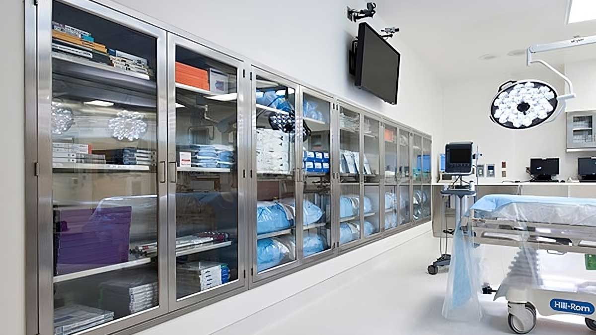 stainless steel glass-front wall cabinets storing surgical supplies for organized sterile instrument access