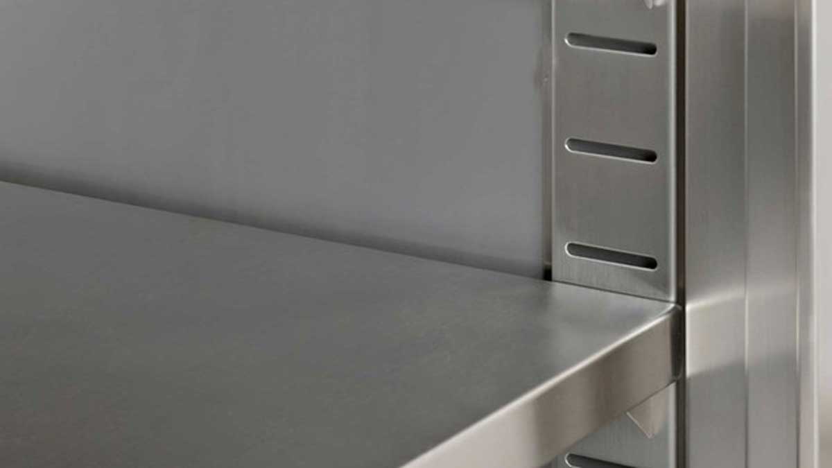 close-up of slotted steel bracket supporting adjustable shelf in storage cabinet
