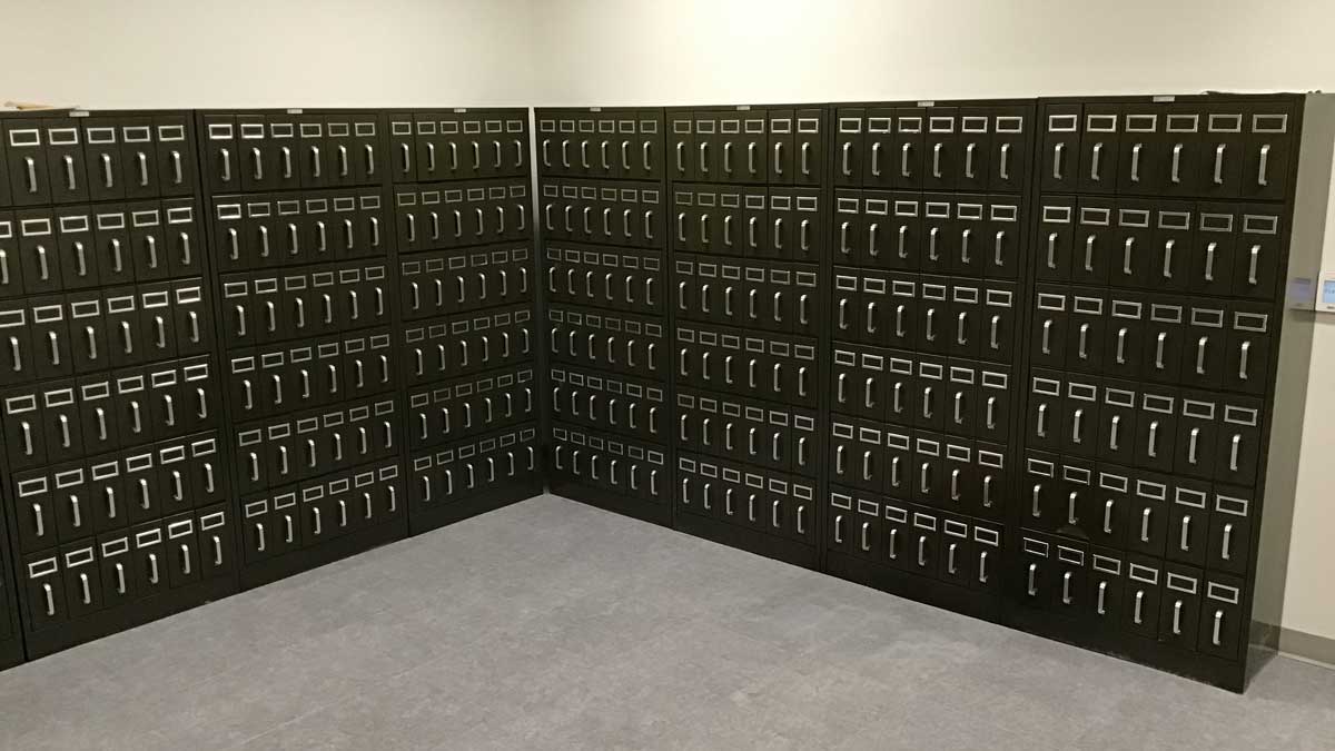 Black metal wall unit with multiple drawers for secure storage and easy organization