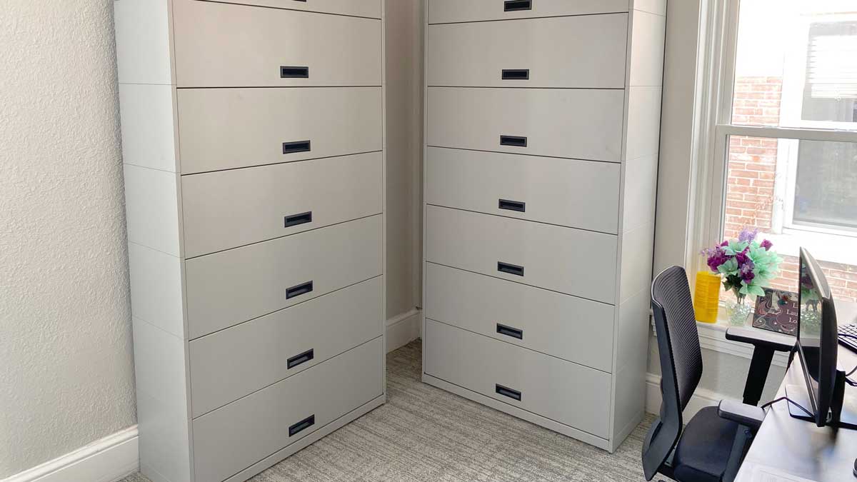 Tall storage cabinets with multiple drawers for organized filing in an office setting