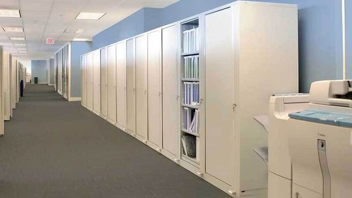 Tall rotary filing cabinets in modern office hallway for secure and space-saving document storage