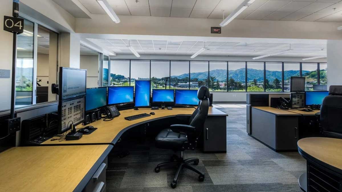 Emergency management room with multiple workstations and large display screens