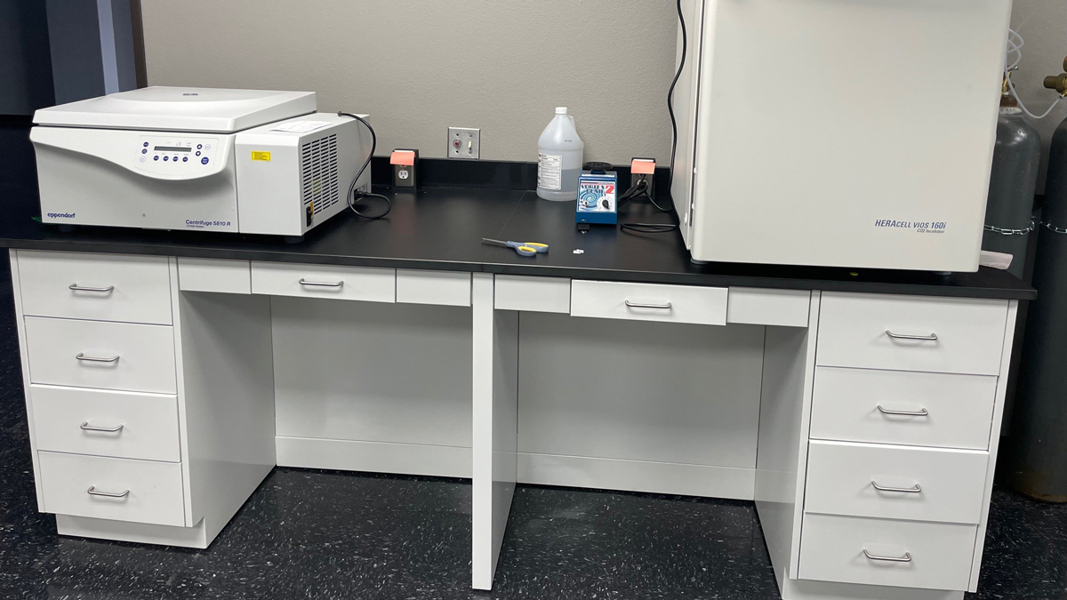 Microbiology lab layout with workstations, cabinets, and storage areas