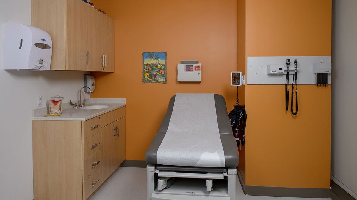 Modular casework and exam table Revit family layout in a medical exam room with sink and upper cabinets