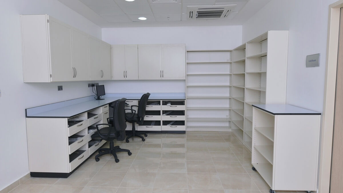 Laboratory modular casework featuring under-counter drawers, overhead cabinets, and open shelving