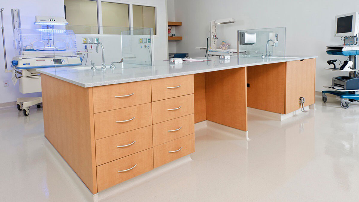 healthcare modular lab casework island with sink and storage drawers in clinical setting