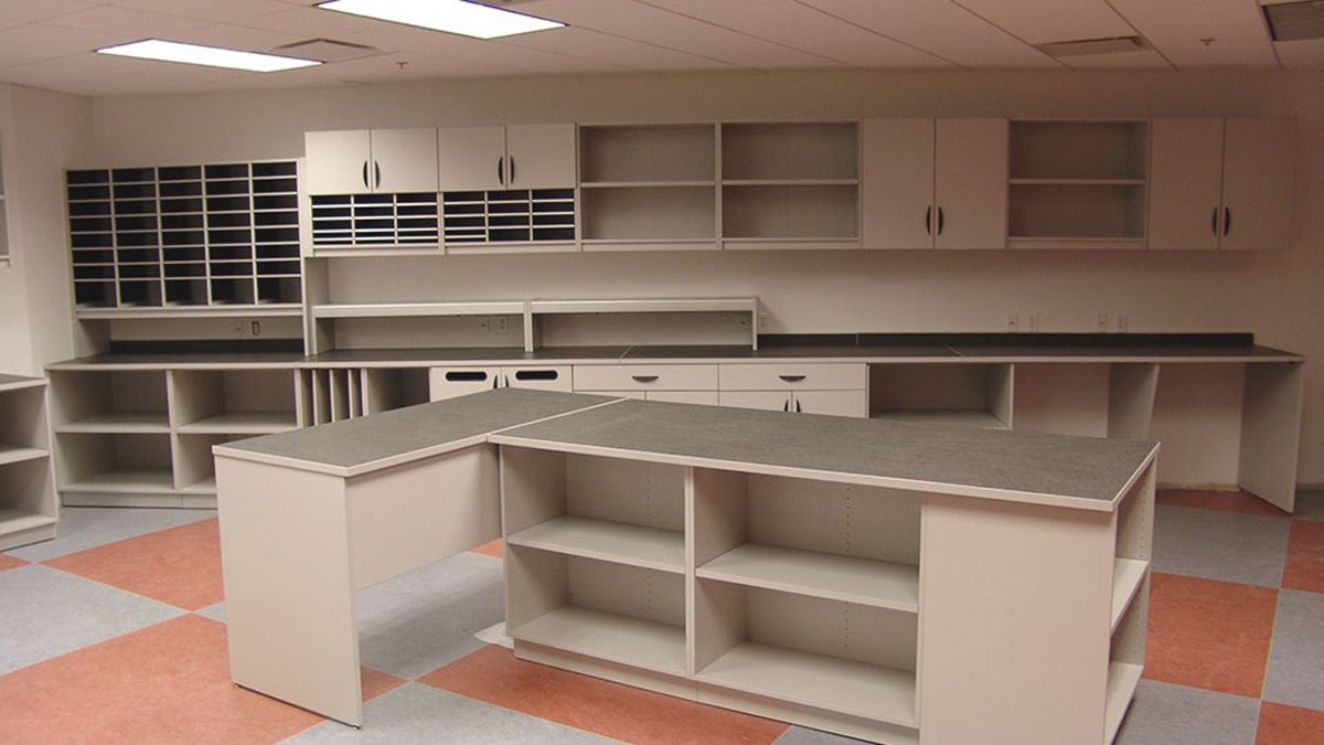 High-capacity modular mailroom casework with open shelving and work surfaces for document sorting and organization