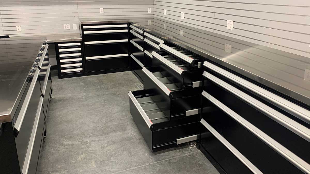 stainless steel tables and storage solutions in equipment room for organized sports gear storage