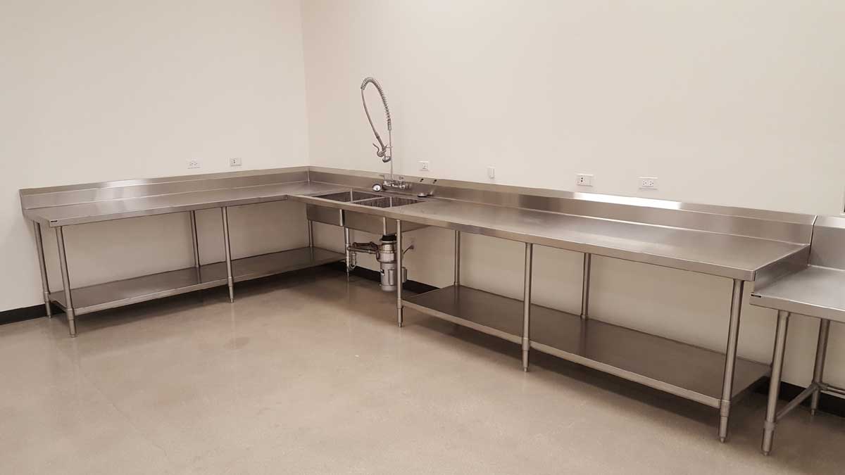 stainless steel laboratory casework with integrated sink and upper cabinets for clean workspace