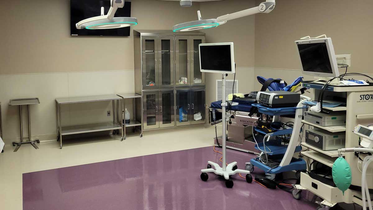 stainless steel medical storage casework with upper and base cabinets in laboratory environment
