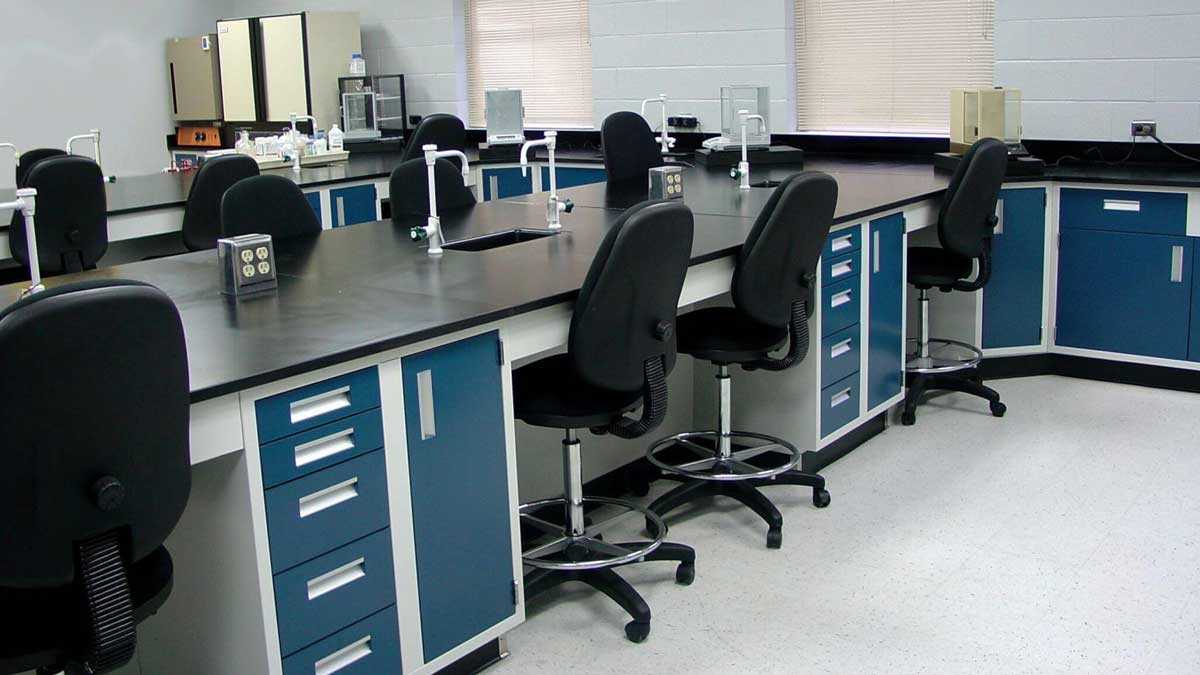laboratory workstation featuring metal casework, drawers, and a computer setup for efficient laboratory workflow
