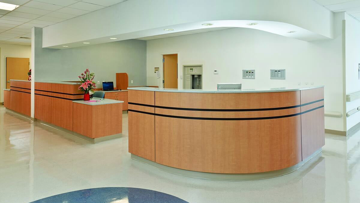 Modular casework reception desk in a healthcare lobby