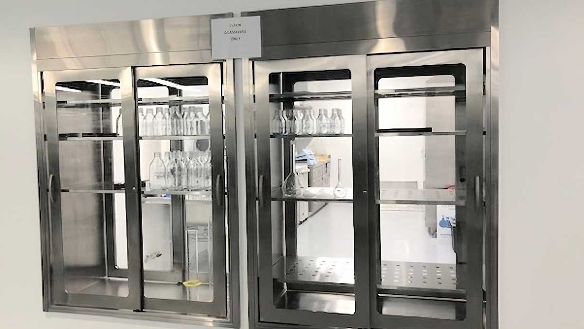 Custom stainless steel casework with pass-through glass door cabinets