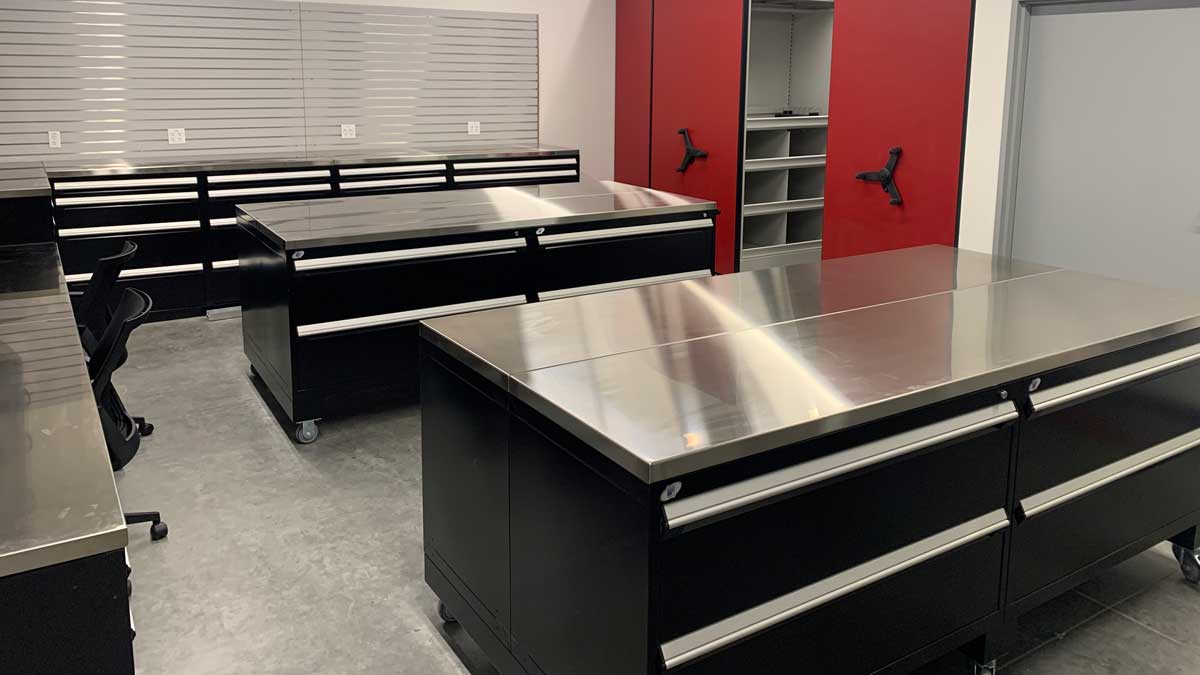 stainless steel top tables in equipment room for organized storage and workspace in laboratory or medical setting