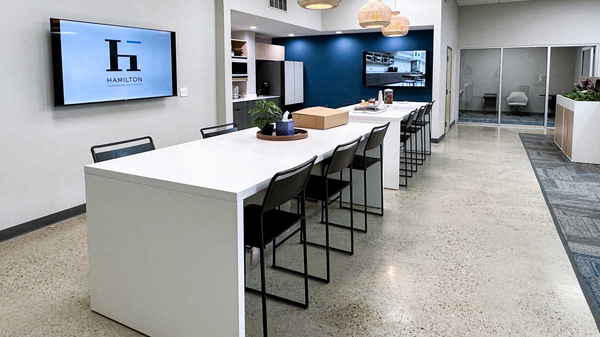 office breakroom island with bar height seating and clean white tabletop for team collaboration