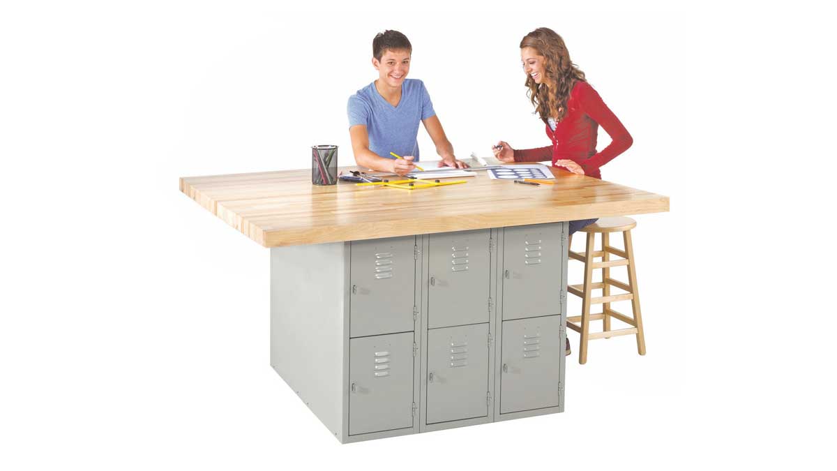 Students using a lab workstation with a wood top and integrated locker storage for secure lab organization