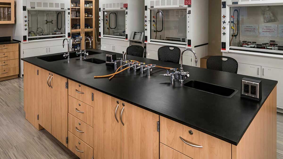 Forensic lab benches with base cabinets and black countertop for secure evidence processing