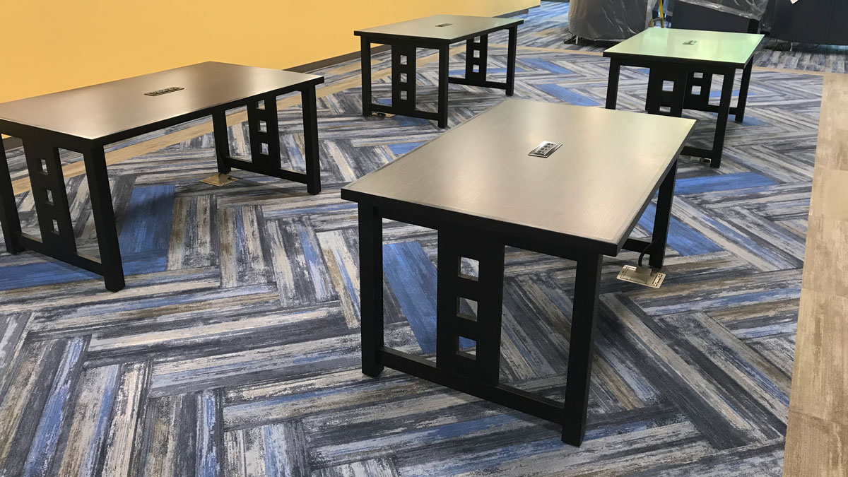 Library tables with built-in power outlets for charging laptops and devices