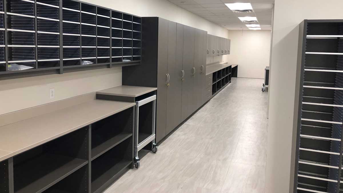 Mailroom modular casework with cubbies and workspace for organized document sorting and mail handling