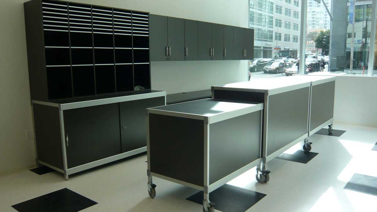 Mailroom workplace with modular storage cabinets and horizontal cubbies for organized mail handling