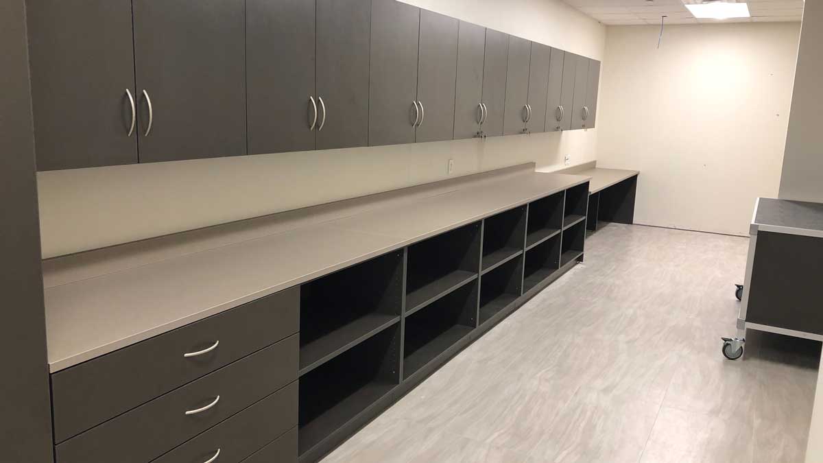 Mailroom modular cabinet system with drawers, shelving, and workspace for efficient sorting