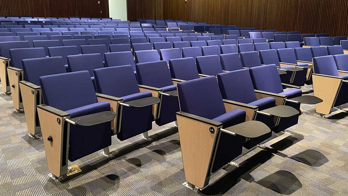 auditorium chairs in a government training facility with built-in desks