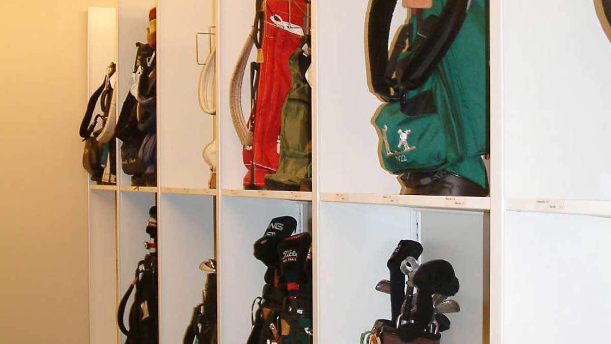 cubby compartment shelving with individual slots for upright golf bag storage in locker rooms