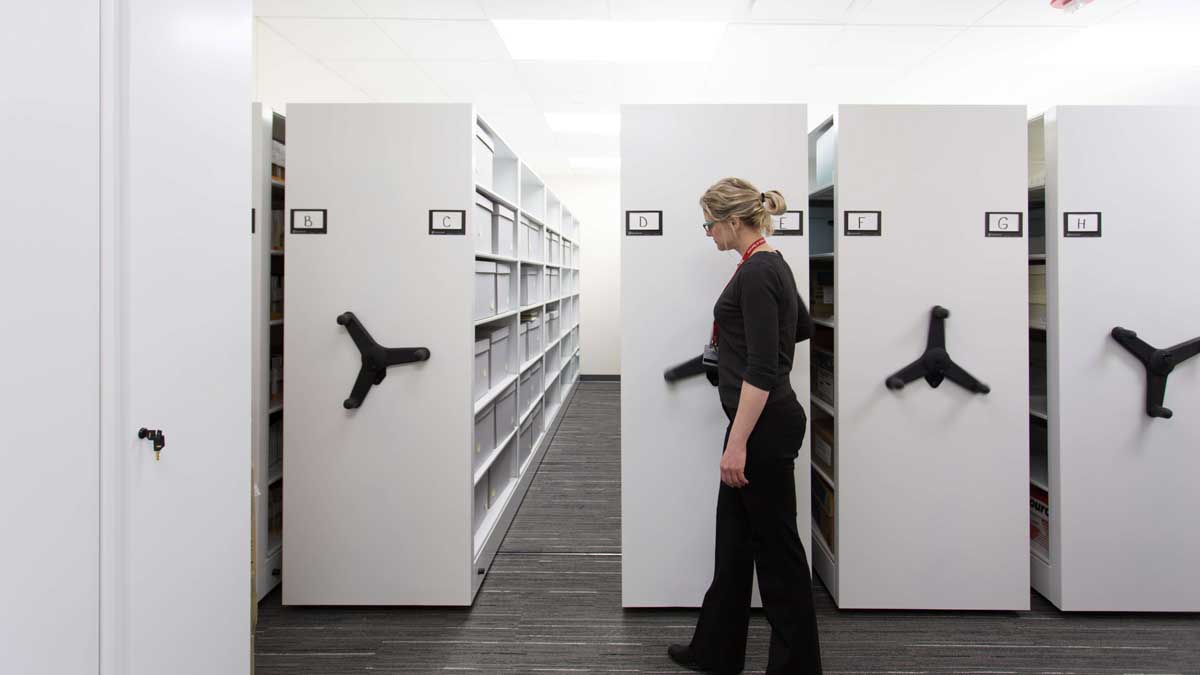 Mechanical-assist mobile shelving storing archival boxes